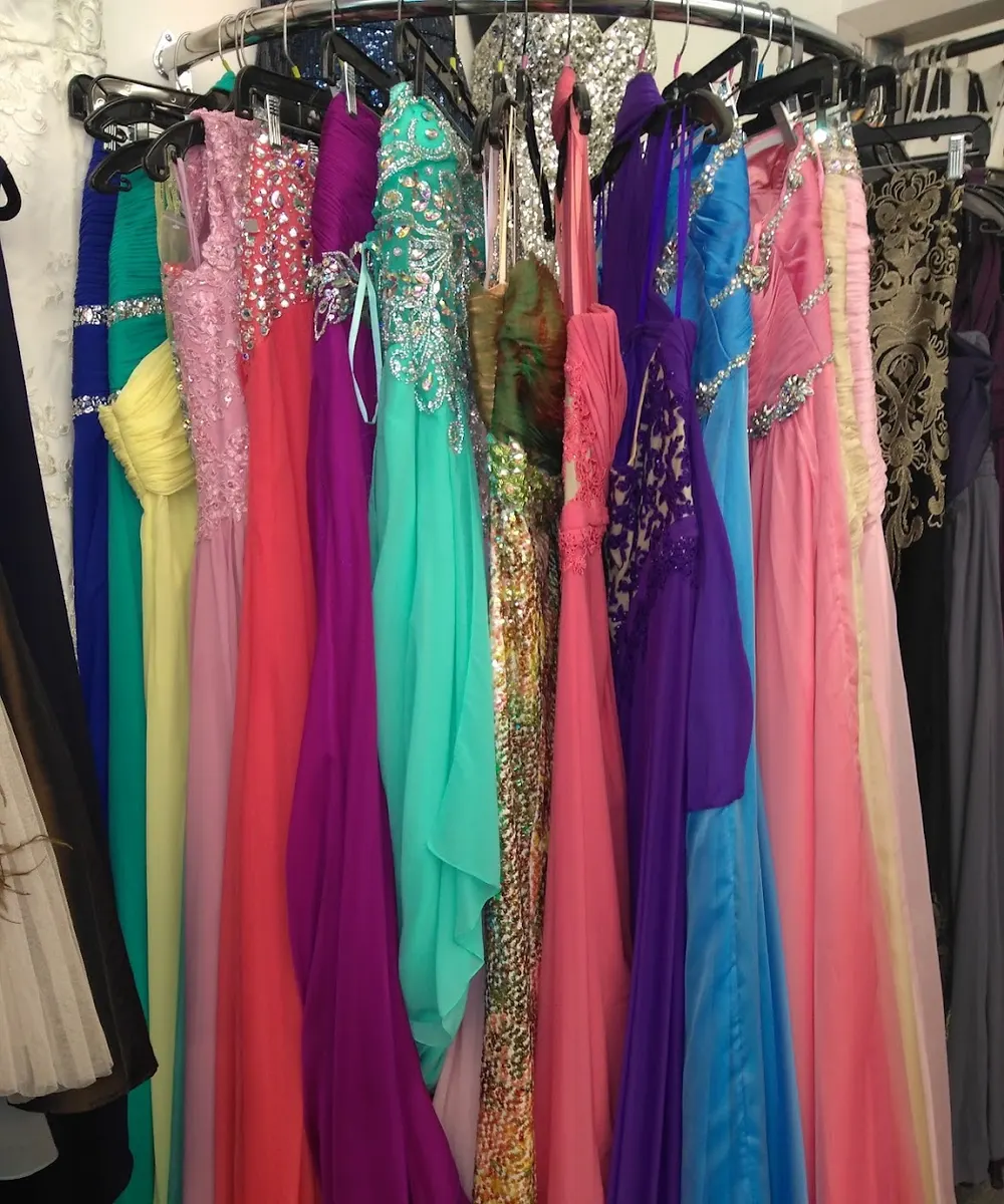 A rack of formal gowns in pink, teal, purple and coral at Kimberly's DeJa Vu Boutique