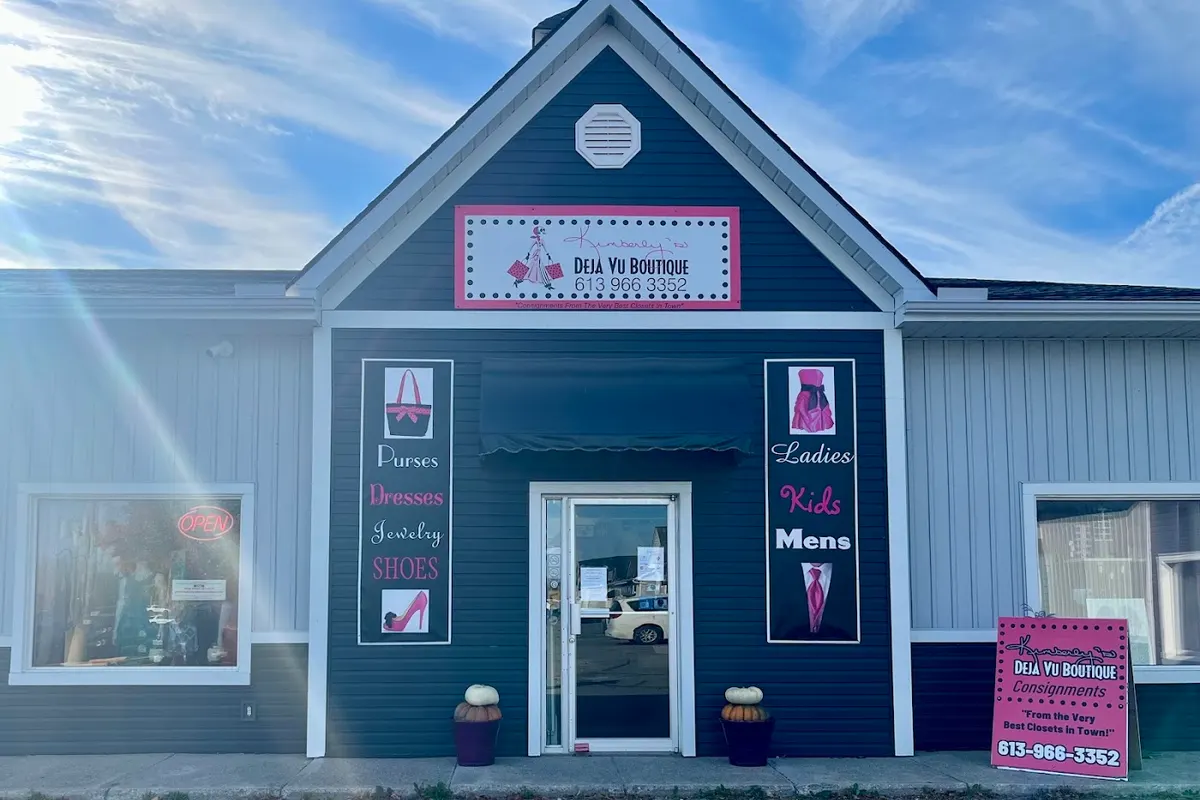 The DeJa Vu Boutique storefront at 6835 Hwy 62 in Belleville, with Purses, Dresses, Jewelry, Shoes, Ladies, Kids and Mens signs